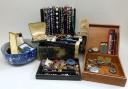 A collection of costume jewellery including beads, brooches,
