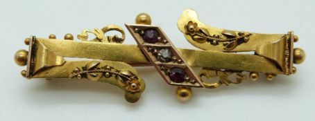 A 15ct gold brooch set with a diamond and rubies, Chester 1900, in box, 3.4g, 4.5 x 1.