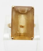 An 18ct gold ring set with a large emerald cut citrine,
