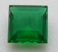 A square cut apple green emerald of approximately 0.