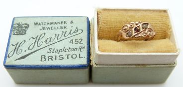A child's ring set with garnet and seed pearls
