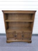 Old Charm or similar oak bookcase with cupboards below W84 x D25 x H103cm