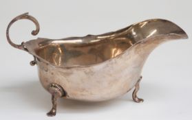 Edward VII hallmarked silver sauce boat raised on three feet, Chester 1909 maker Barker Brothers,