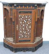 A 19thC Moorish / Eastern style cabinet with carved central door flanked by shelves with arched top