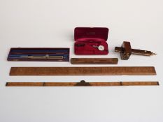 Tools and scientific instruments including a brass inlaid rosewood, mortice gauge, folding ruler,