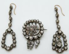 A pair of Victorian earrings set with foiled paste and a similar brooch