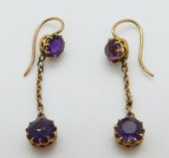 A pair of Victorian earrings set with an amethyst to each with a further drop amethyst attached on