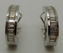 A pair of 18ct white gold earrings set with 22 baguette cut diamonds to each,
