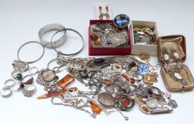 A silver bangle, brooches including silver set with butterfly wing,