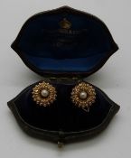 A pair of Edwardian gold earrings in the form of flowers set with seed pearls,