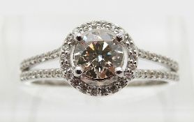 An 18ct white gold ring set with a round brilliant cut diamond of approximately 0.