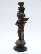 Bronze or similar figural candlestick in the form of putti with violin, indistinctly signed to base,