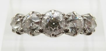 An 18ct gold ring set with five graduating old cut diamonds, the centre diamond approximately 0.