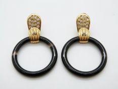 A pair of 18ct gold earrings set with cubic zirconia and onyx rings