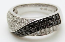 A 14ct white gold ring set with 26 black diamonds, total approximately 0.