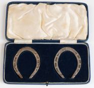 Cased pair of George VI novelty hallmarked presentation miniature horseshoes,