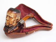 Cased Meerschaum pipe with carved figural decoration, length 15.