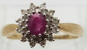 A 9ct gold ring set with an oval ruby surrounded by diamonds,