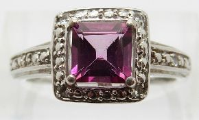 A silver ring set with a synthetic pink sapphire and diamonds, size O/P, 3.