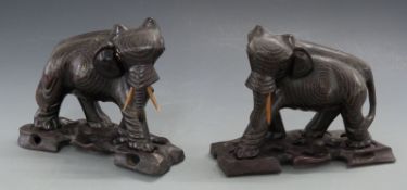 Two inlaid Indian or similar elephants with stands,