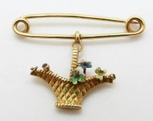 A yellow metal brooch in the form of a posy basket,
