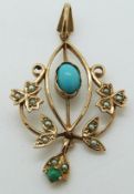 A 9ct gold Art Nouveau pendant set with two turquoise cabochons and seed pearls