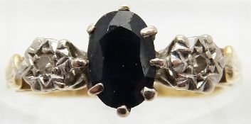 An 18ct gold ring set with a sapphire and two diamonds,