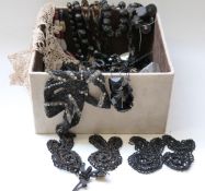 A collection of jet including carved Victorian beads depicting thistles and clover, carved beads,