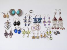 Thirteen pairs of silver earrings set with various gemstones and a pair of Eastern white metal
