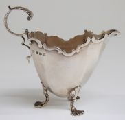 Victorian hallmarked silver footed cream jug with scroll handle,