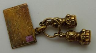 A yellow metal charm in the form of a letter and two seals, 3.