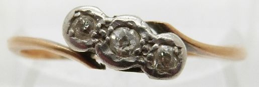 A 9ct gold ring set with three diamonds in a platinum setting,