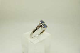 A 9ct white gold ring set with two oval cut sapphires and six diamonds, size P, 2.