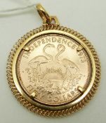 An Independence 1973 fifty dollar coin in an 18ct gold mount, 20.