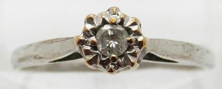 A 9ct white gold ring set with a diamond in an illusion setting,