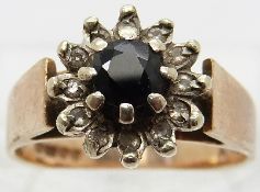 A 9ct gold ring set with a sapphire surrounded by diamonds,