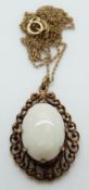 A 9ct gold pendant set with an oval opal on a 9ct gold chain