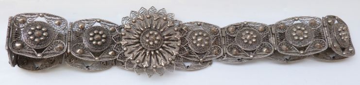 A filigree white metal belt,