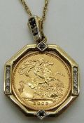 A 2003 gold half sovereign in a 9ct gold pendant mount set with sapphires and diamonds on a 9ct