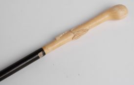 A 19thC ebonised wood and carved ivory walking stick/cane with rope and swag decoration,