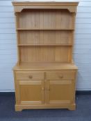 Modern beech or similar dresser with plate rack to top and two drawers and two cupboards to base,