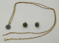 A 9ct gold pendant set with emeralds and diamonds in a cluster with matching earrings and a 9ct