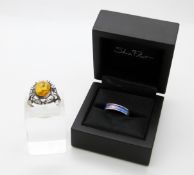 A silver ring set with a rainbow enamel by Shelia Fleet,