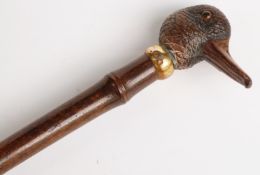 Late 19thC parasol with carved figural duck handle, yellow metal collar impressed 'Brigg',