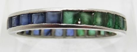 A platinum eternity ring set with emeralds and sapphires,