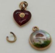 A Victorian intaglio pendant depicting a mushroom and a red guilloché enamel heart pendant set with
