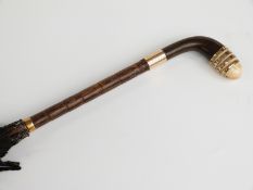 Victorian parasol with ivory, horn and yellow metal handle on bamboo stick,