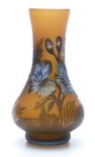 Galle style cameo glass vase with blue flowers on a burnt orange ground, 14.5cm tall.