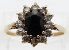 A 9ct gold ring set with a sapphire surrounded by zircon,