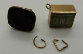 A 9ct gold fob set with and intaglio seal and a 9ct gold charm set with a one pound note, 4.